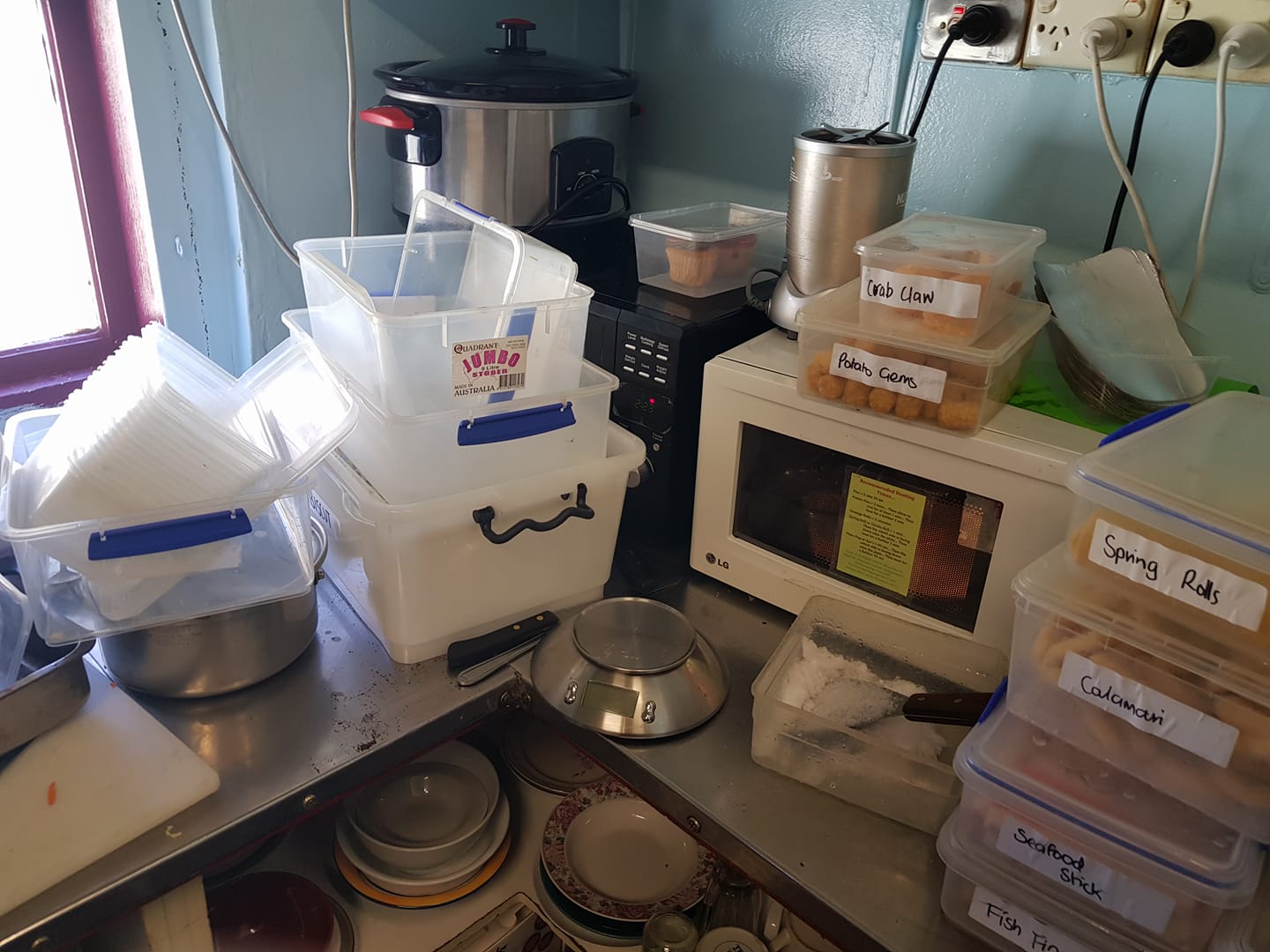Mess of a kitchen. Cleaning up personal bowls plates the owner and her family use. They just dump it all there, workers clean up after them all..jpg